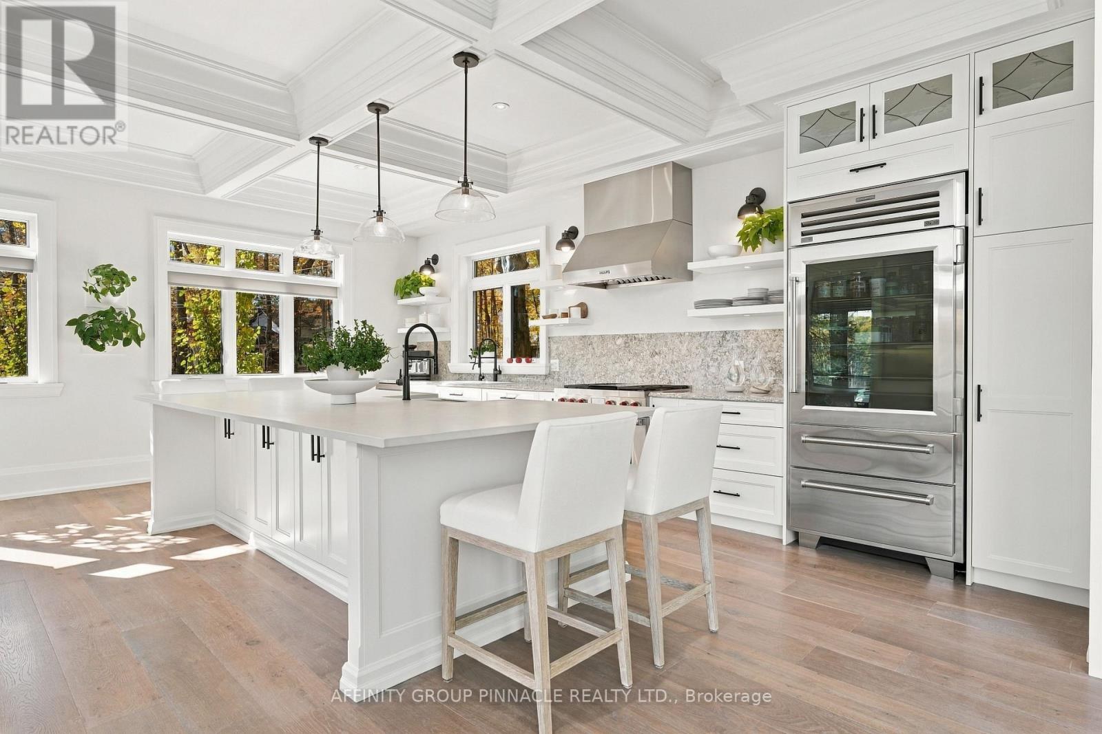 Chef’s kitchen with white cabinetry and a large island
