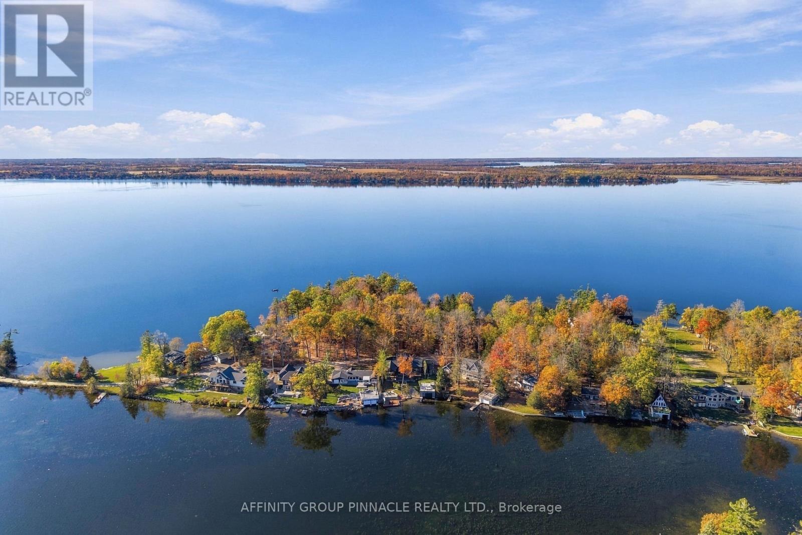 Aerial view of the property’s Cameron Lake shoreline and surrounding autumn landscape